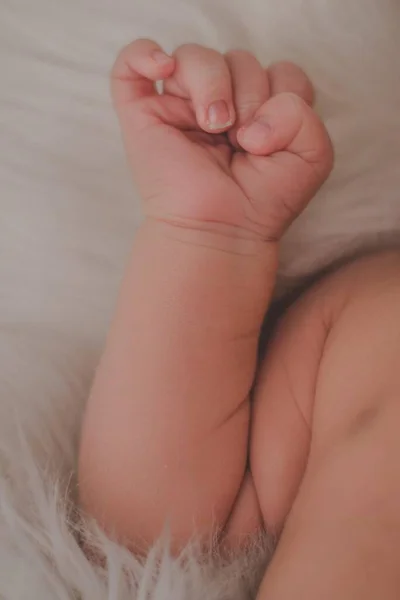 depositphotos_363024280-stock-photo-vertical-shot-newborn-baby-arm
